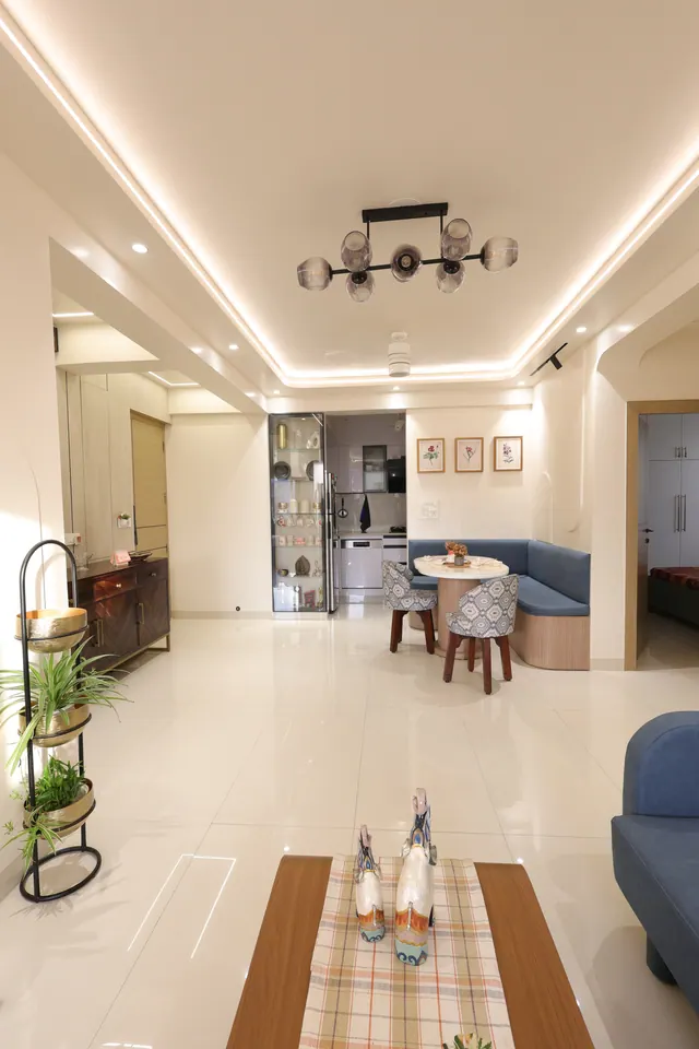 Drawing, dining, and kitchen areas in a small apartment with a cohesive design theme, featuring space-saving furniture, integrated storage solutions, and a harmonious color palette